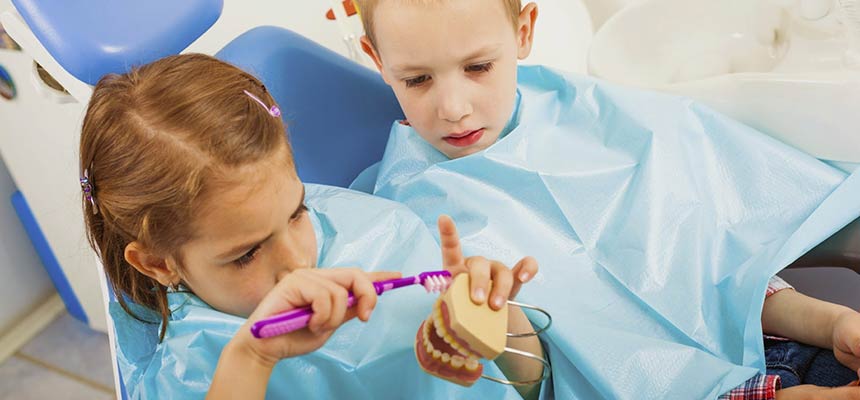 Two children sitting in the dentist chair