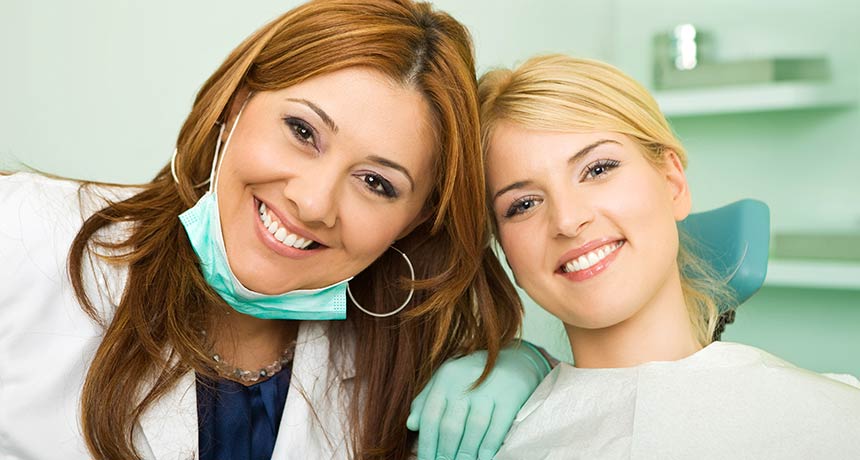 Patient and dentist smiling together